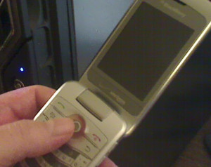 A bad quality photo of a Blackberry Pearl 8230 smartphone.