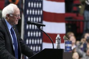 A photo of Bernie Sanders being confronted by a sparrow in Portland, Oregon.